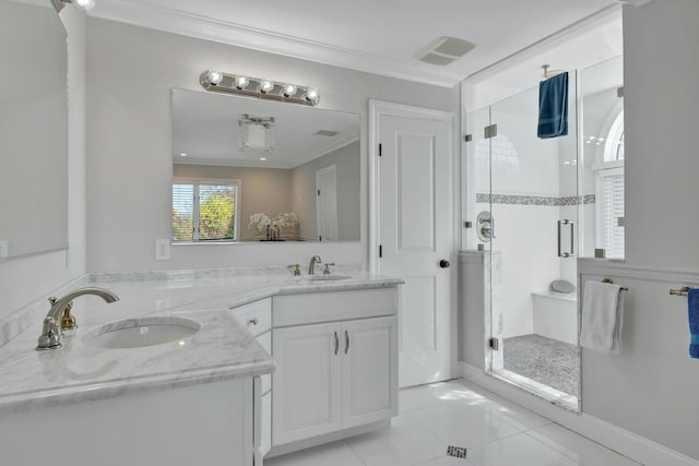 full bath featuring a sink, double vanity, a stall shower, and ornamental molding