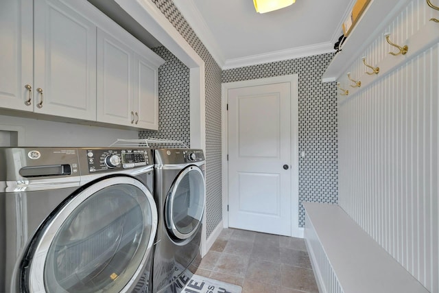 laundry area with washing machine and clothes dryer, tile patterned flooring, cabinet space, and crown molding