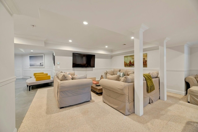 living area with a decorative wall, recessed lighting, crown molding, and a wainscoted wall