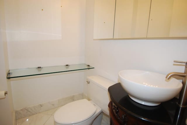 half bathroom with toilet and vanity