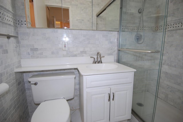 bathroom featuring toilet, vanity, tile walls, decorative backsplash, and a stall shower