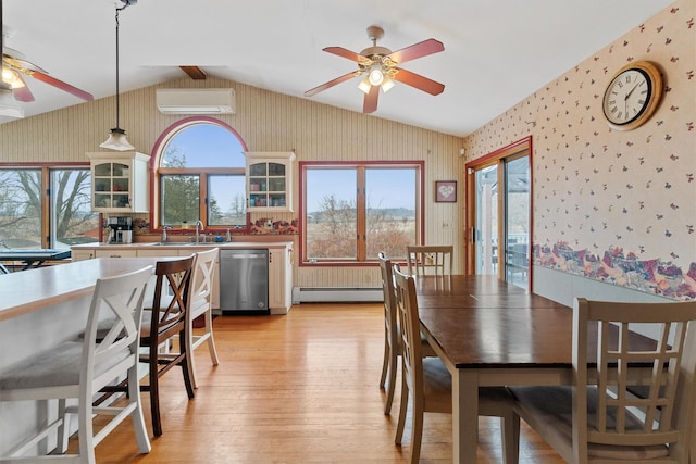 dining area with light wood-style flooring, baseboard heating, an AC wall unit, vaulted ceiling, and wallpapered walls