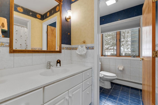 bathroom with a baseboard radiator, toilet, tile walls, vanity, and tile patterned floors