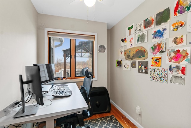 office area with ceiling fan, baseboards, and wood finished floors