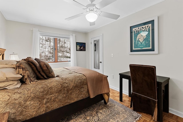 bedroom featuring baseboards, ornamental molding, and a ceiling fan