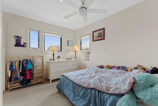 bedroom with a ceiling fan and light colored carpet