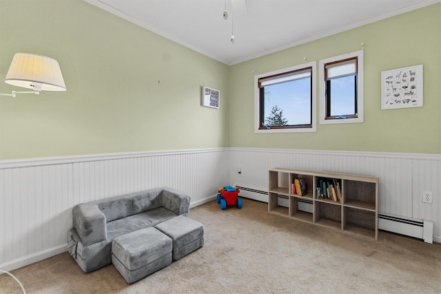 living area with carpet, wainscoting, and crown molding