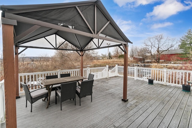 deck with outdoor dining area and a gazebo