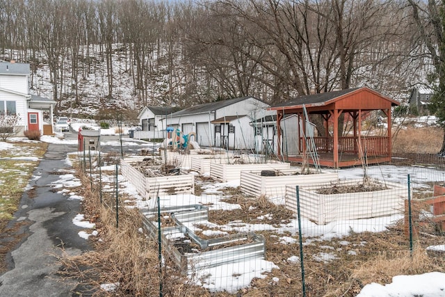 exterior space with an outdoor structure, a residential view, a vegetable garden, and a gazebo