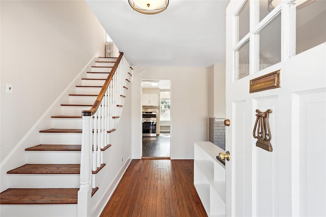 stairs with hardwood / wood-style floors