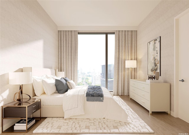 bedroom featuring light wood-style floors and wallpapered walls