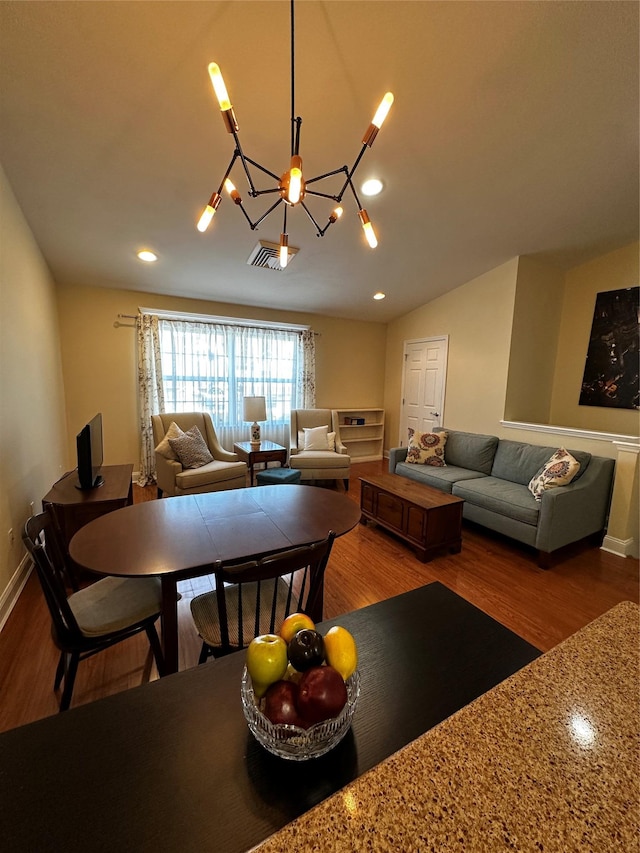 dining space featuring lofted ceiling, baseboards, wood finished floors, and recessed lighting