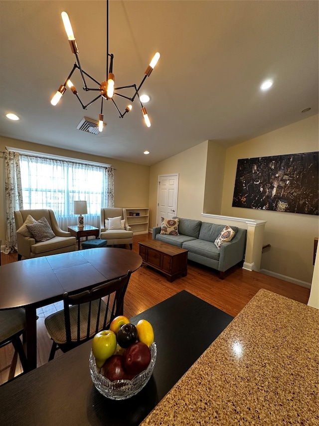 living area featuring vaulted ceiling, recessed lighting, and wood finished floors