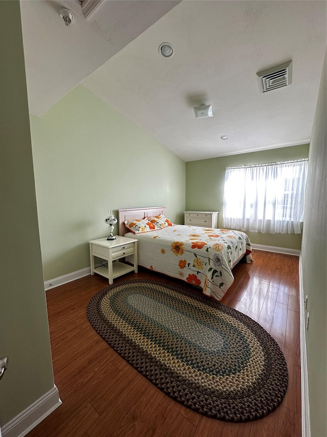 bedroom with wood finished floors and baseboards