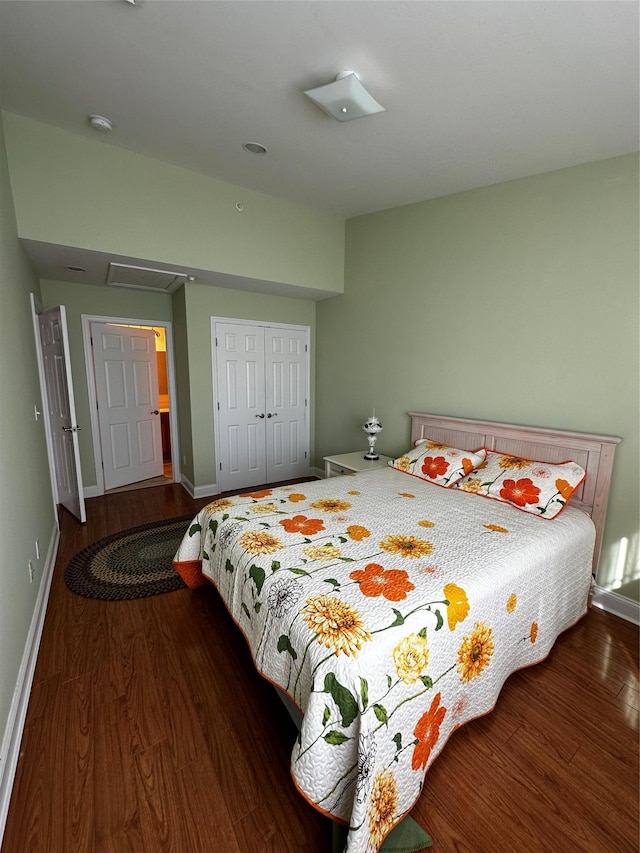 bedroom with baseboards, a closet, and wood finished floors