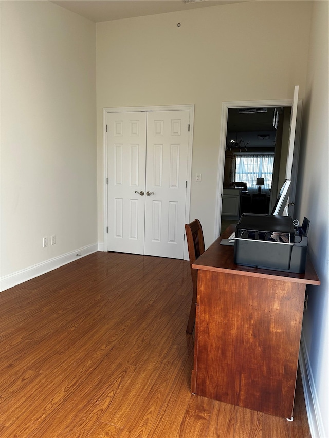 office featuring baseboards and wood finished floors