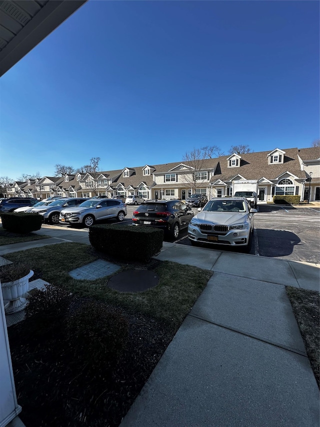 uncovered parking lot with a residential view