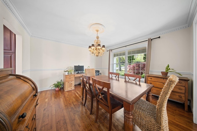 dining room featuring wood-type flooring, ornamental molding, and a notable chandelier