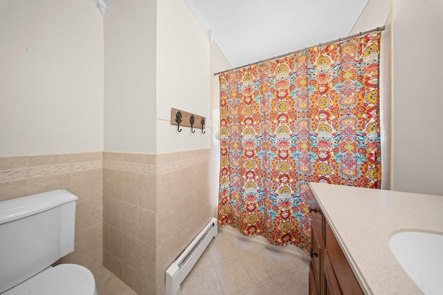 bathroom featuring baseboard heating, vanity, toilet, tile patterned floors, and a wainscoted wall