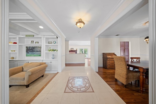 entryway featuring baseboards, visible vents, ornamental molding, and tile patterned flooring