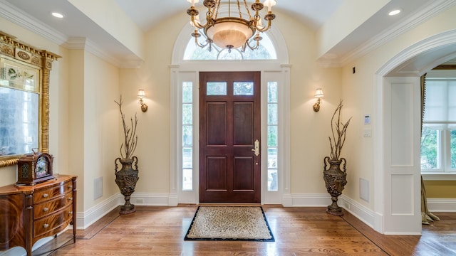 entryway featuring baseboards, a chandelier, wood finished floors, and recessed lighting