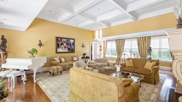 living area with light wood finished floors, arched walkways, coffered ceiling, and beam ceiling