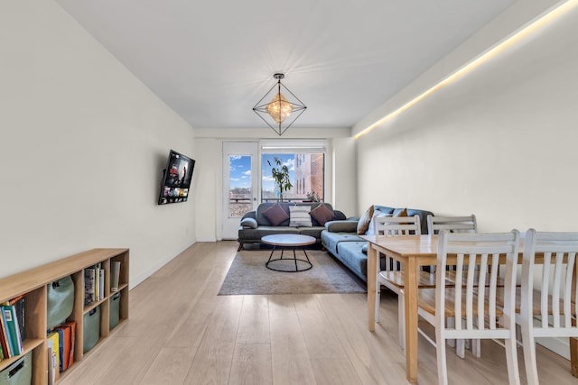 living room featuring a notable chandelier and wood finished floors