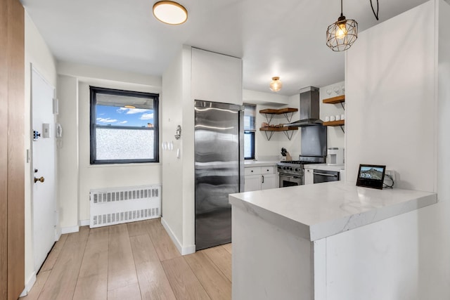 4705 Henry Hudson Pkwy W Unit 7G, Bronx, NY 10471 - kitchen with light wood-style floors, appliances with stainless steel finishes, wall chimney exhaust hood, open shelves, and radiator heating unit