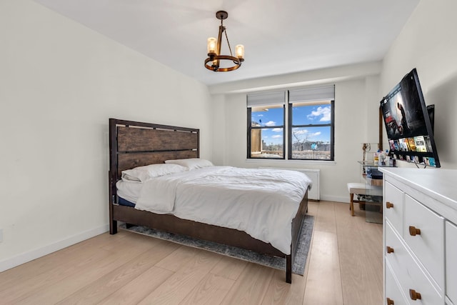 4705 Henry Hudson Pkwy W Unit 7G, Bronx, NY 10471 - bedroom featuring light wood-style flooring, baseboards, and a chandelier