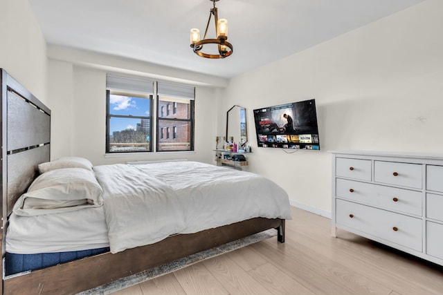 4705 Henry Hudson Pkwy W Unit 7G, Bronx, NY 10471 - bedroom featuring baseboards, a notable chandelier, and light wood finished floors