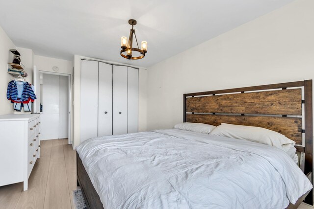 4705 Henry Hudson Pkwy W Unit 7G, Bronx, NY 10471 - bedroom with light wood-type flooring, a closet, and a notable chandelier