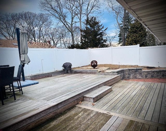 deck with a fenced backyard