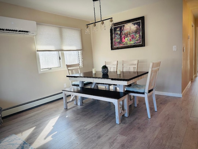 dining area featuring a baseboard radiator, baseboards, an AC wall unit, and wood finished floors