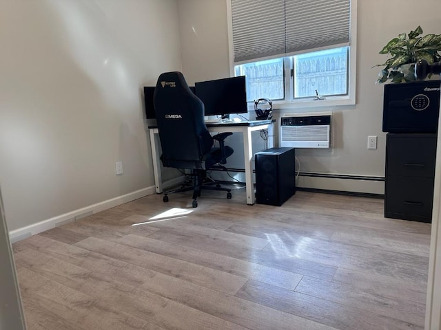 home office with a baseboard heating unit, baseboards, light wood-style floors, and a wall mounted AC