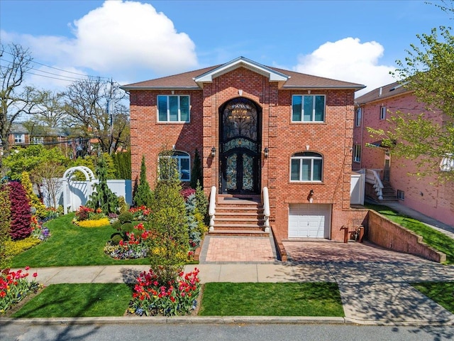 view of front facade featuring driveway, a garage, fence, french doors, and brick siding