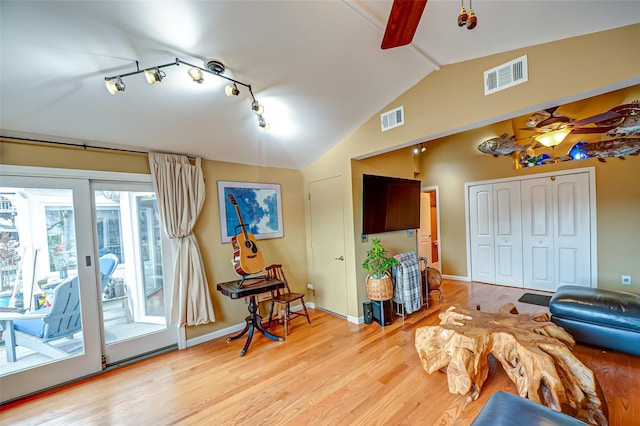 interior space with visible vents, vaulted ceiling, and a ceiling fan