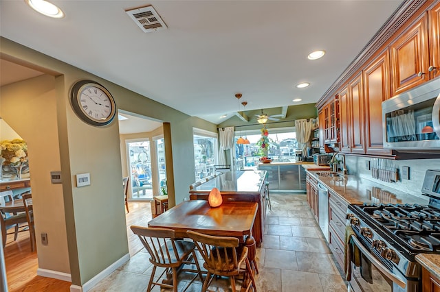 kitchen featuring stainless steel appliances, a wealth of natural light, visible vents, and a sink