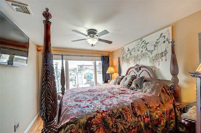 bedroom with baseboards, visible vents, a ceiling fan, and wood finished floors