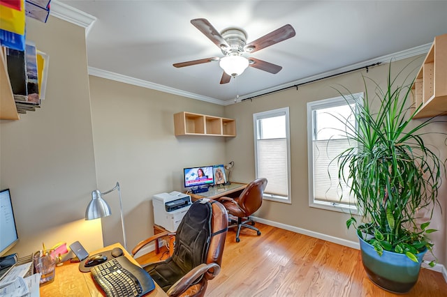 office space with a ceiling fan, crown molding, light wood-style flooring, and baseboards