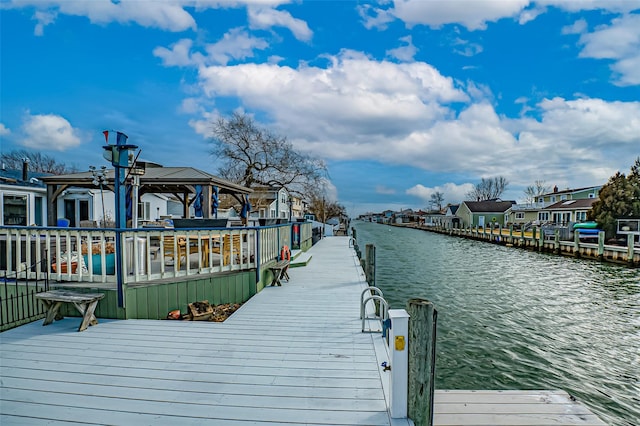 view of dock featuring a water view and a residential view