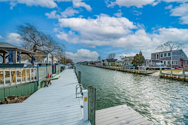 dock area featuring a residential view and a water view