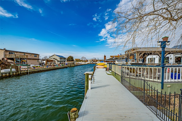 dock area featuring a residential view and a water view