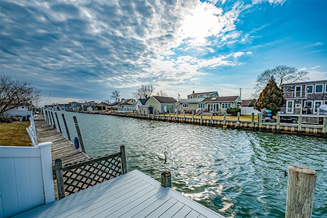 dock area featuring a residential view and a water view