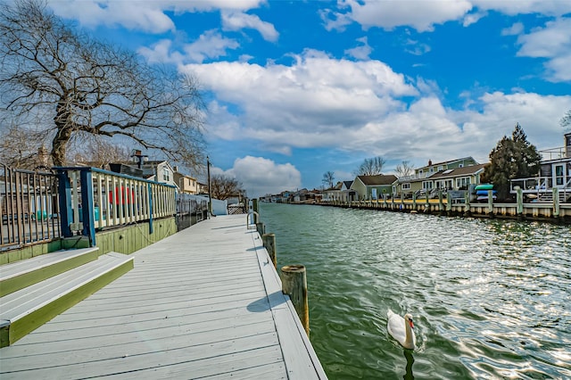 dock area with a water view and a residential view