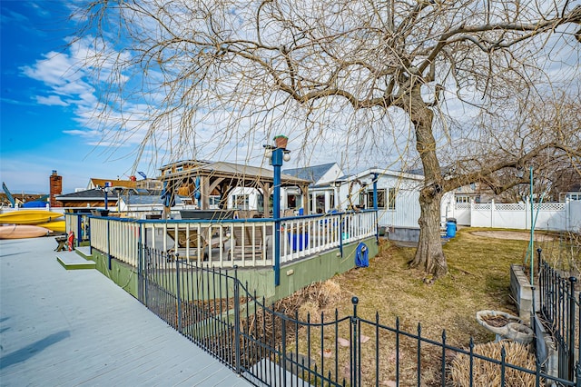 view of community featuring fence private yard and a dock