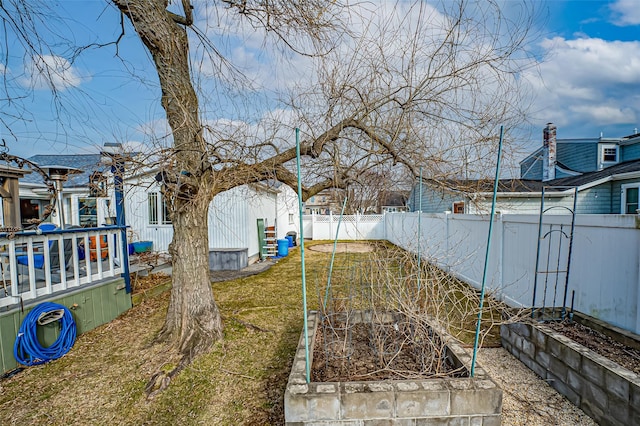 view of yard with a fenced backyard and a garden