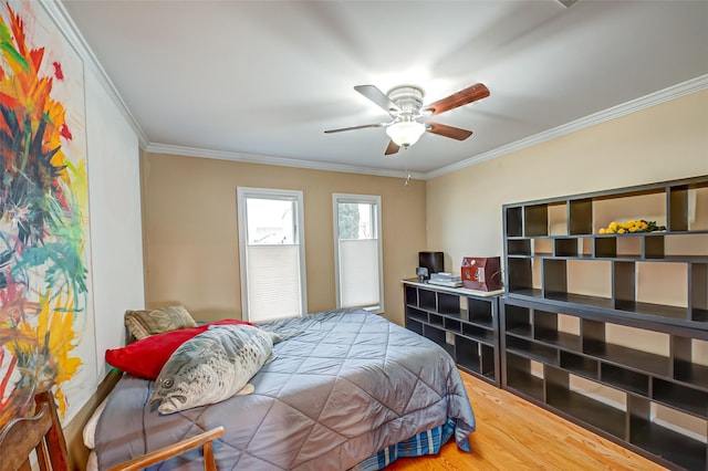 bedroom featuring ornamental molding, ceiling fan, and wood finished floors