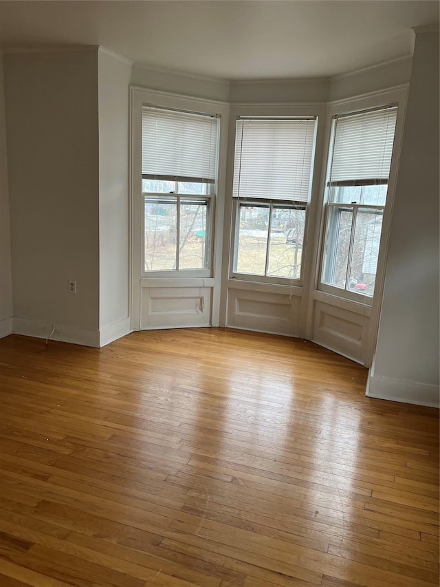 unfurnished room with wood-type flooring and baseboards