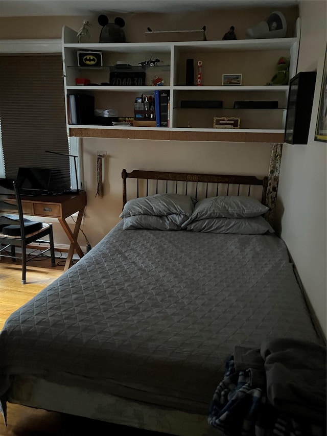 bedroom with wood finished floors