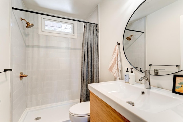 full bath featuring vanity, a shower stall, and toilet